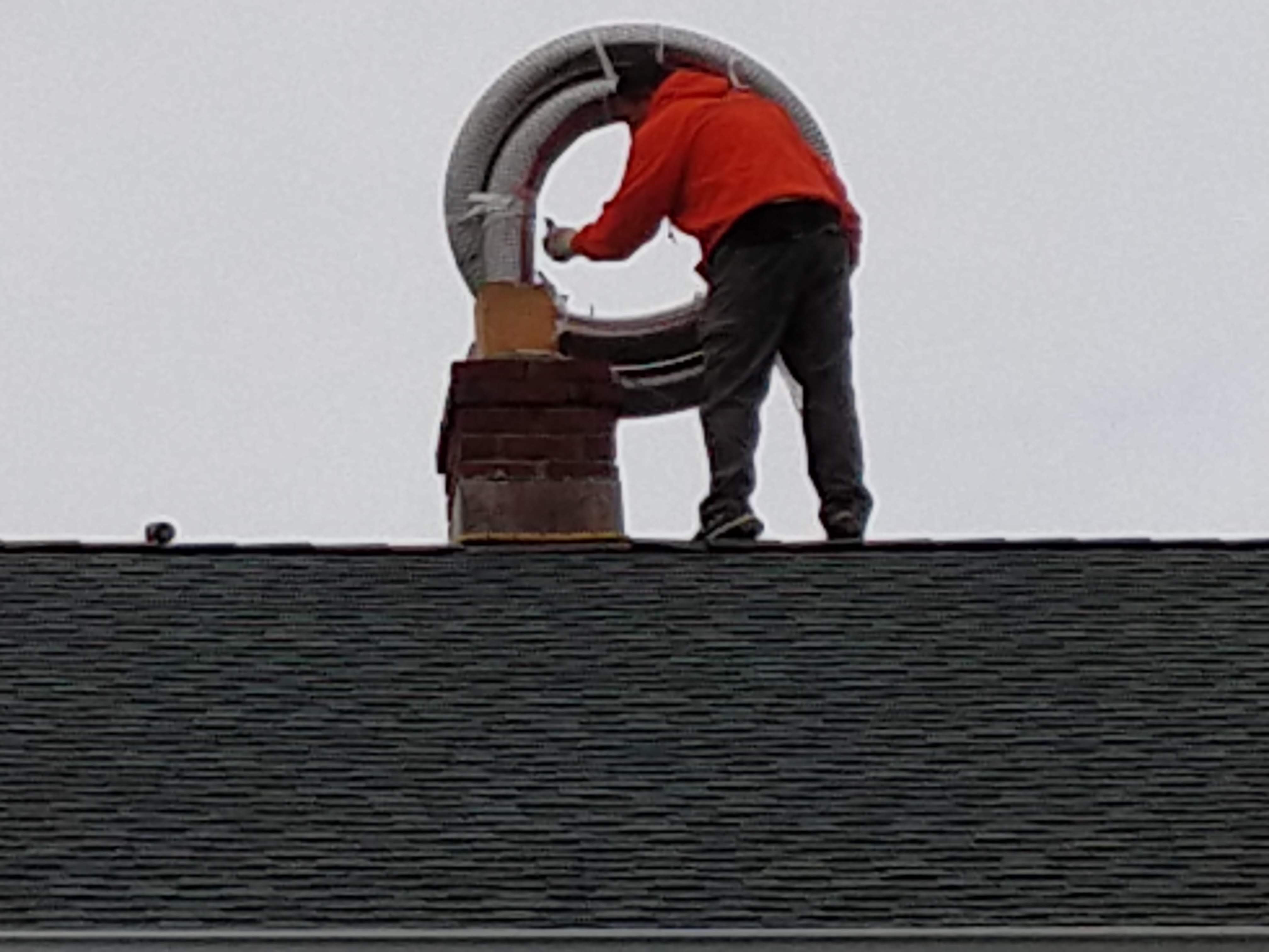 Flexible stainless chimney liner being installed in Baldwin, New York